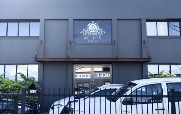 Building with Aether signage above the front doors | Featured image for Plumbing Project.