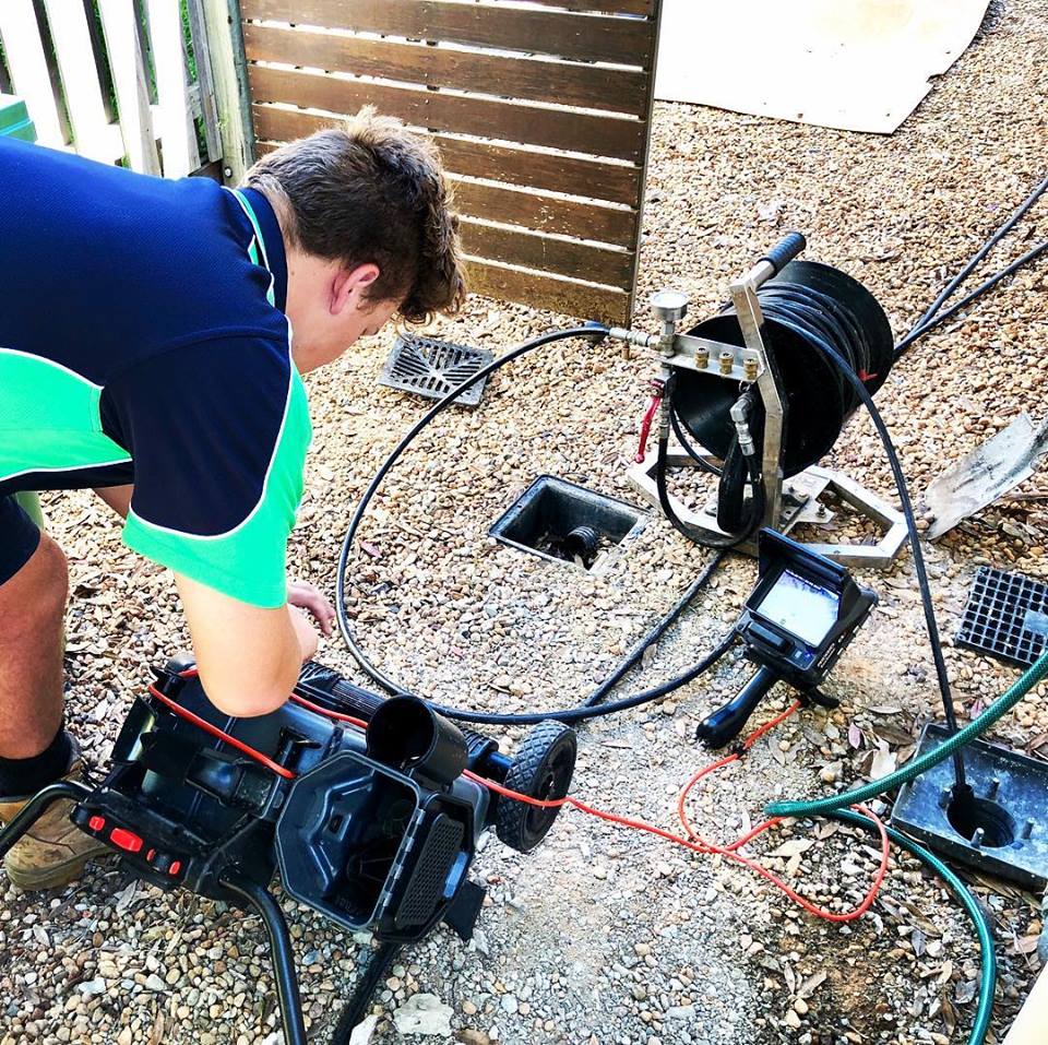 Akins plumber checking a drain with a CCTV equipped device | Featured image for Drain Cleaning Brisbane.
