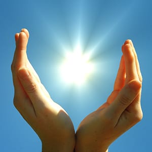 Hands cupping the sun | Featured image for Your local plumber template.