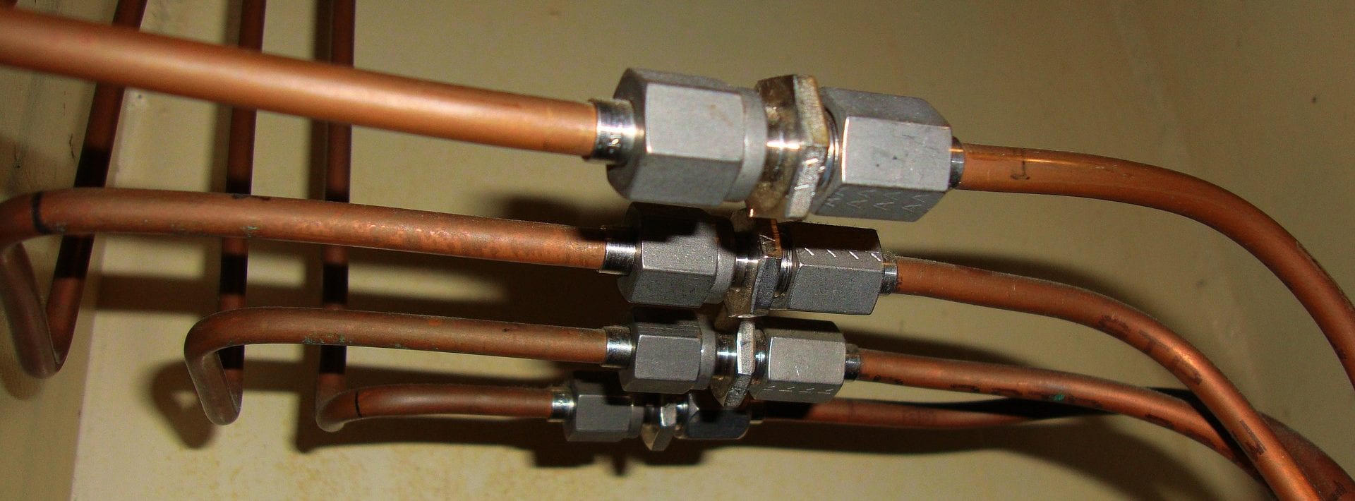 A close up of metal pipes | Akins Plumbing.