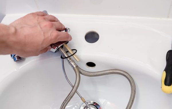 Plumber checking a sink | Featured image for Testimonials.
