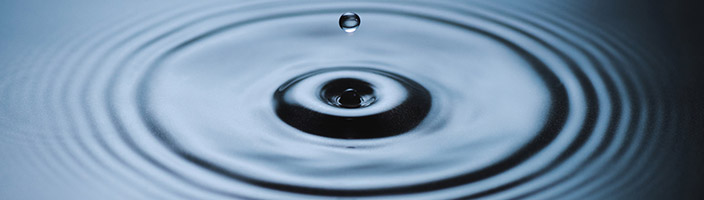 Water droplets falling into a pool of water | Featured image for the Eco Plumbing page from Akins Plumbing.