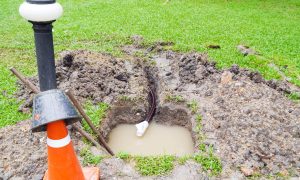 Hole filled with water and in need of water leak repair | Featured image for the Plumbing Repair Services Page from Akins Plumbing.